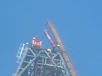 AHCC being removed from the top of the derrick structure